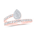 rose gold Pear-shaped diamond cluster with a diamond twist band that elegantly connects to the left side of the ring, creating a unique and sophisticated design