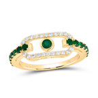 Yellow gold diamond paperclip ring with emeralds at the center and additional emeralds on the band.