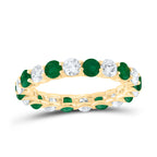 Ring featuring alternating emerald and white diamonds all across the band, creating a vibrant and elegant design