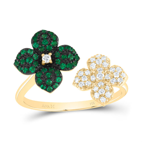 Cuff ring featuring two flowers on either end: one with a diamond center surrounded by emerald stones set with black prongs, and the other with white diamonds and a diamond center, accented with yellow prongs.