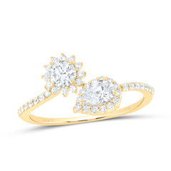 Front view Round and pear-shaped solitaire diamonds set side by side on a cuff ring, with the round stone positioned higher than the pear. Each stone is surrounded by a halo of diamonds, and the band features diamonds halfway around with smooth gold on the rest