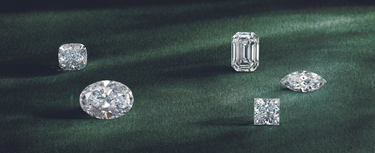 Five different stone shapes displayed on a green background.