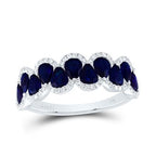 Ring featuring pear-shaped blue sapphires with alternating orientations (one facing up and the other facing down), accented with white diamonds for a striking and elegant design.