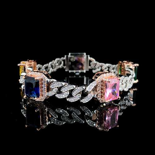 Silver Cuban bracelet with four square stones in yellow, blue, pink, and green, displayed on a black background